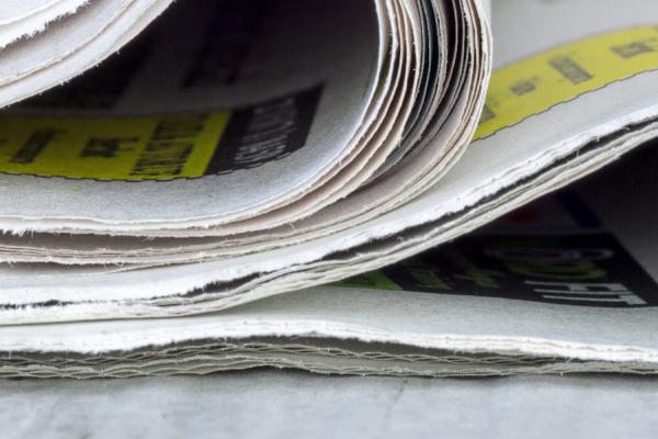 A close up of a small pile of newspapers
