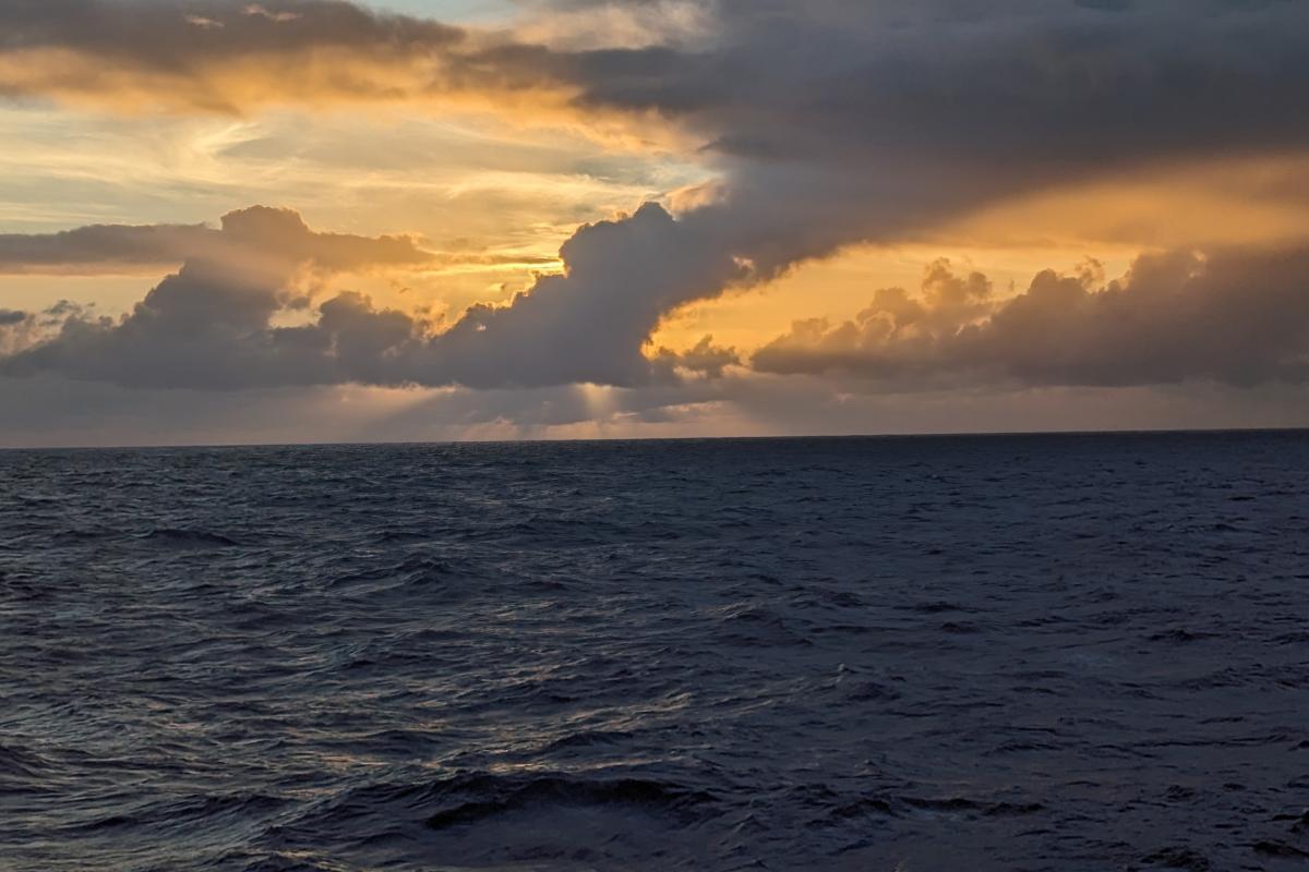 Sun peeks through the clouds over the Pacific Ocean.
