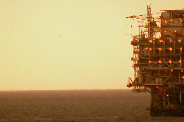 An oil platform at sunset.