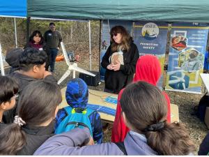 ANCHORAGE, Alaska – Maureen De Zeeuw, a wildlife biologist with the Bureau of Ocean Energy’s Alaska OCS Region, explains the basics of wind-turbine energy to a group of 6th-graders at the Campbell Creek Science Center here May 7, 2024. De Zeeuw was one of several staff members from BOEM and its sister agency, the Bureau of Safety and Environmental Enforcement, participating in the Bureau of Land Management’s Outdoor Week 2024. BSEE photo by Guy Hayes.