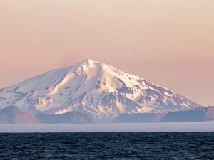 Volcanic island Great Sitkin rises from the ocean.