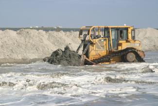 Dozer pushing sand