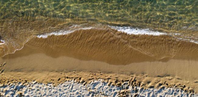 Aerial View of Sandy Beach and Ocean with Waves