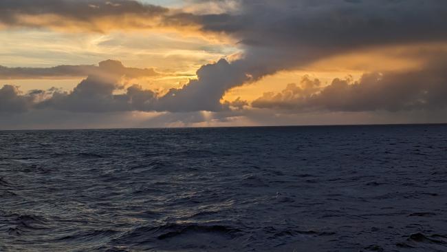 Sun peeks through the clouds over the Pacific Ocean.