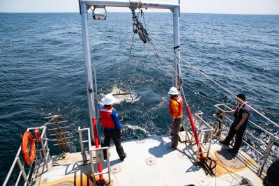 scientist working on boat in the ocean