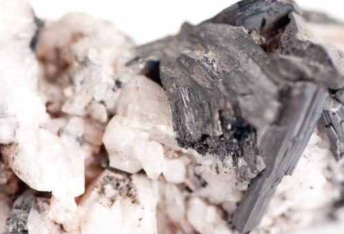 Close up of manganese ore, with a light and dark colored crystalline structures..