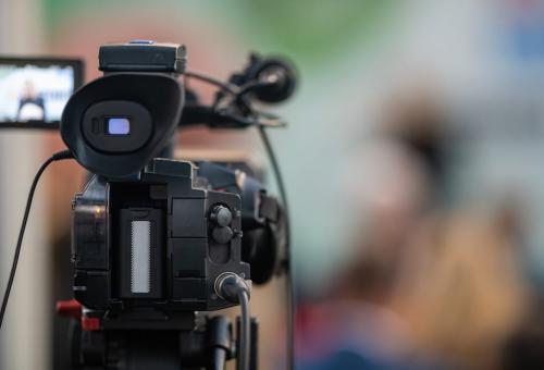 Behind the scenes, a media camera capturing the moments of an event.