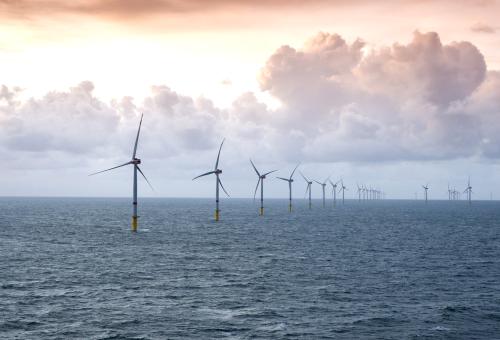 sunset over offshore wind farm