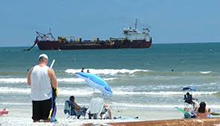 A dredge ship offshore pumps OCS sand to shore for a Duval County coastal restoration project in 2011. USACE photo.