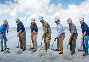 The Ground-Building shovel ceremony on Ship Island, Miss., May 29, 2019. Pictured (L to R): Lance Hatten,  Regional Director, National Park Service; Joe Spraggins, Executive Director, Mississippi Department of Marine  Resources; U.S. Rep. Steve Palazzo (Miss.-4th); Col. Sebastien Joly, Commander, Mobile District, US Army  Corps of Engineers; Gulfport Mayor Billy Hewes; Gulf Islands National Seashore Superintendent Dan Brown; and Mike Celata, Gulf of Mexico Region  Director, Bureau of Ocean Energy Management. (Photo: Breault, National Park Service)