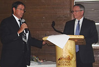 Richard Desselles (left), representing BOEM's Office of Strategic Resources, and AASG President Jonathan D. Arthur address conference attendees before signing the agreement between the two organizations.    