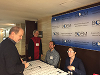 Mary Boatman, standing in the red dress, welcomes attendees to the Nov. 2016 Atlantic Science Forum in Sterling, VA. Photo by Marjorie Weisskohl, BOEM