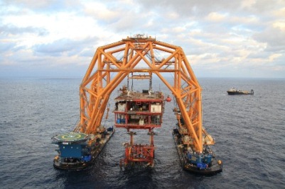 Severed top of a platform being lifted by Versabar